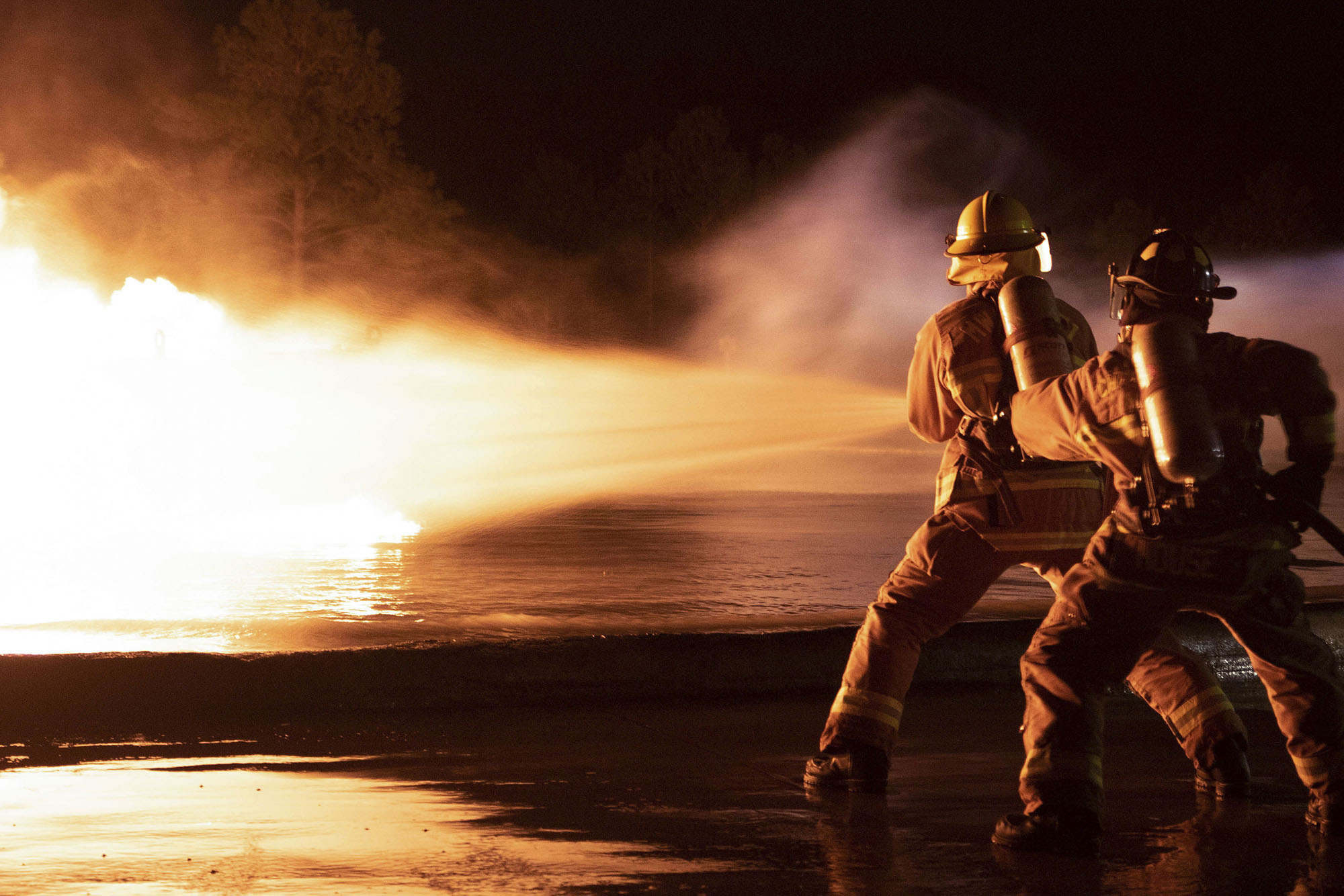 Marine Corps aircraft rescue and firefighting specialists with Headquarters and Headquarters Squadron and Marine Wing Support Squadron 271, conduct live fuel fire burn training on Marine Corps Air Station Cherry Point, N.C., Feb. 3, 2021.