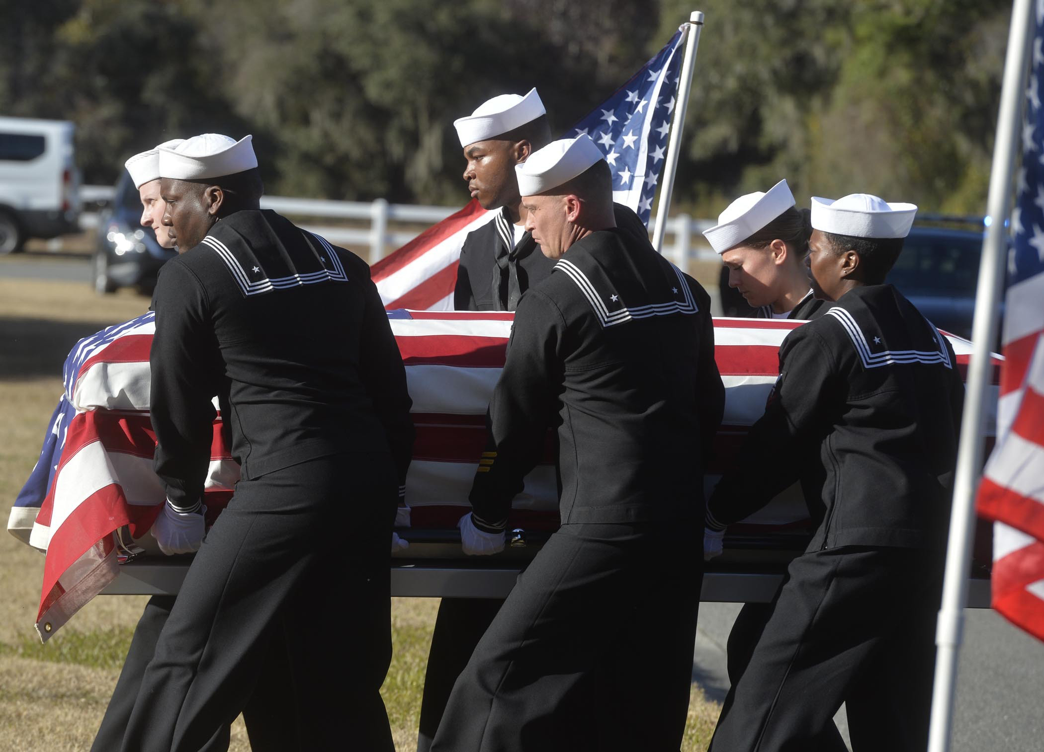 In this Dec. 16, 2019 file photo, sailors carry the casket of Cameron Walters at Oak Hill Cemetery in Richmond Hill, Ga.