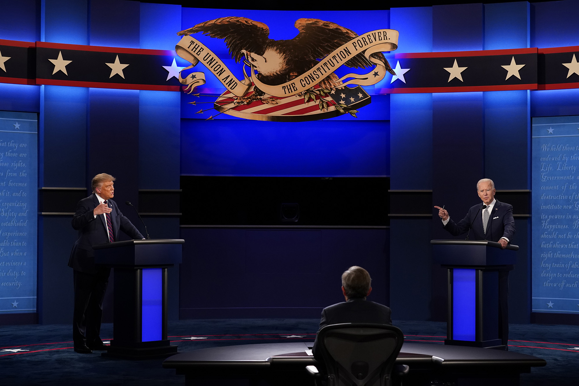 President Donald Trump, left, and Democratic presidential candidate former Vice President Joe Biden, right, with moderator Chris Wallace, center, of Fox News during the first presidential debate Tuesday, Sept. 29, 2020, at Case Western University and Cleveland Clinic, in Cleveland.
