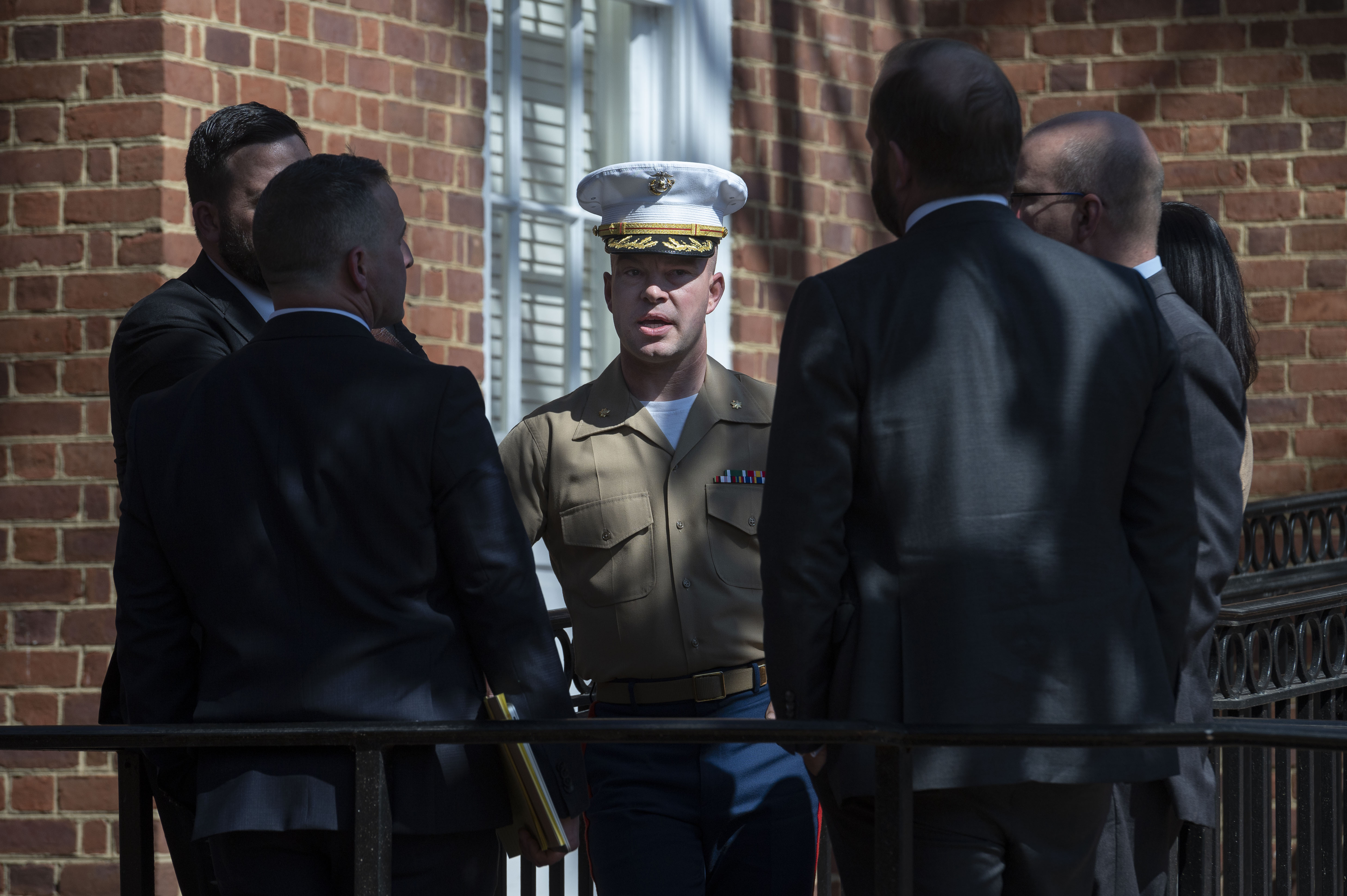 U.S. Marine Corps Major Joshua Mast, center, talks with his attorneys during a break in the hearing in an ongoing custody battle over an Afghan orphan, at the Circuit Courthouse in Charlottesville, Va., Thursday, March 30, 2023.